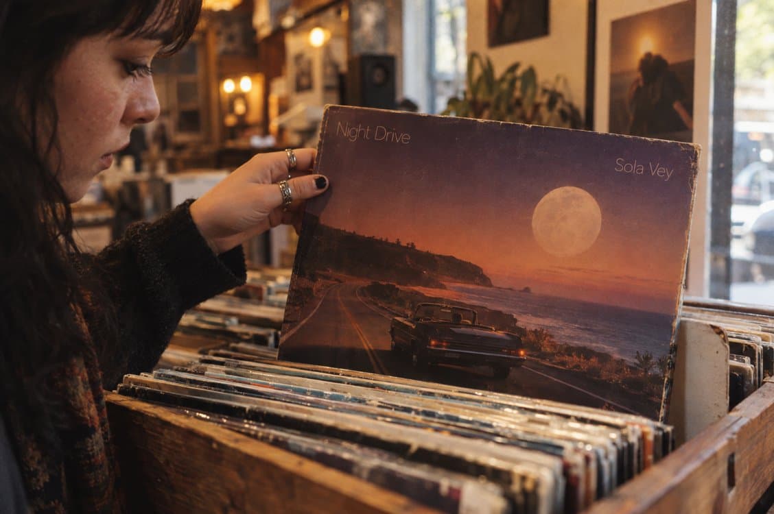 A record store shopper holding an album cover made from a prompt