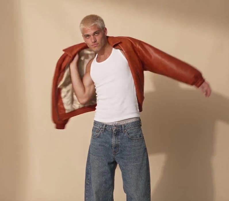 A model in an orange jacket generated with Wask