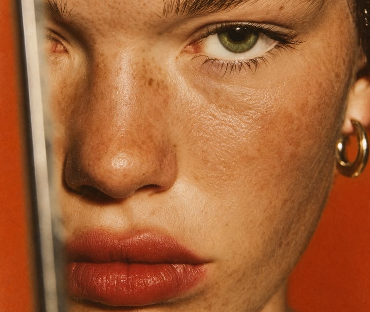 Casting reference: a freckled face seen in a mirror